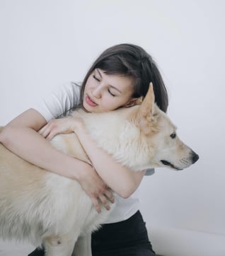 girl hugging dog